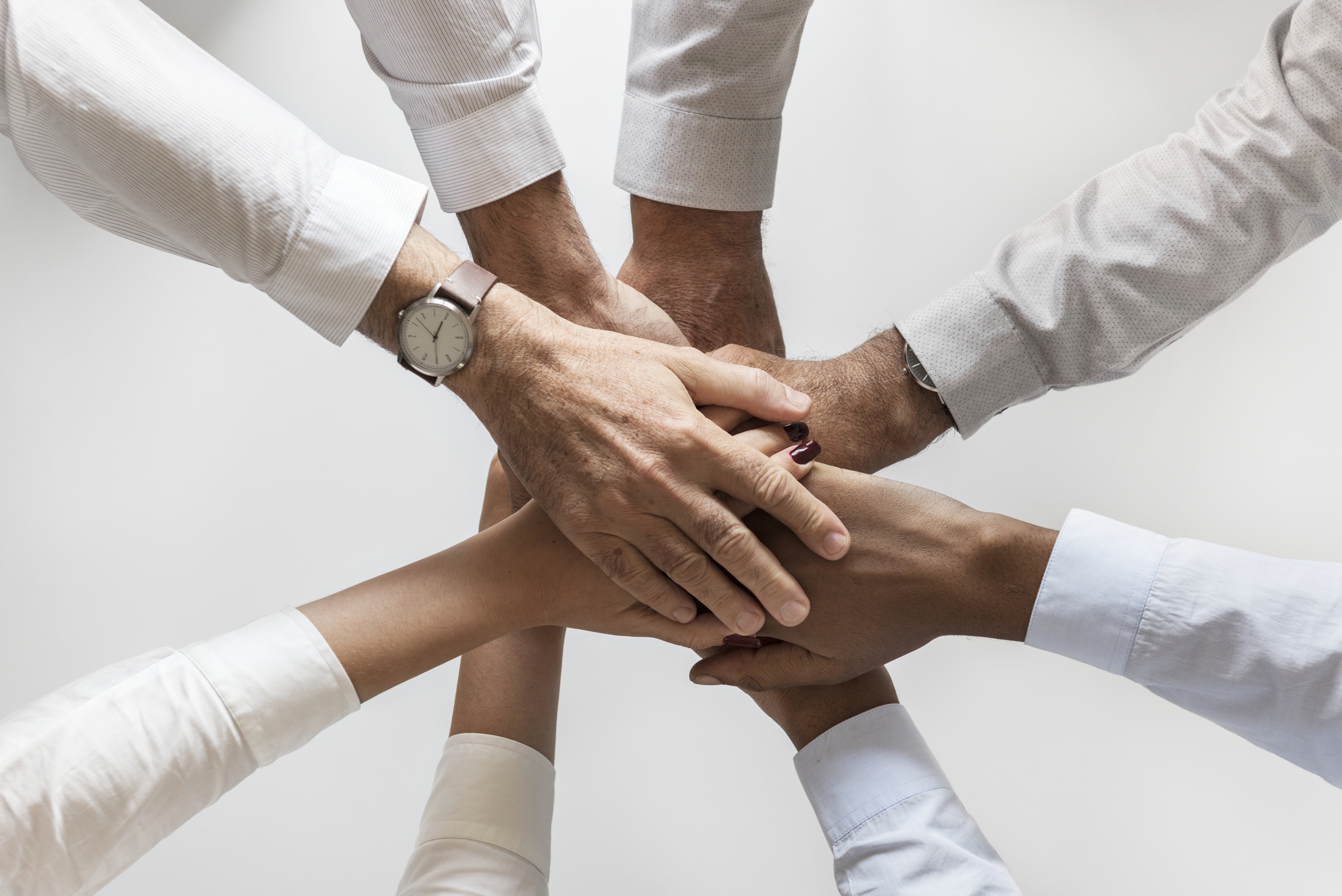 Business hands joined together teamwork Hórus Engenharia e Manutenção de Elevadores